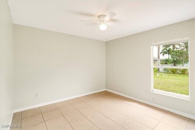 empty room with light tile patterned floors and ceiling fan