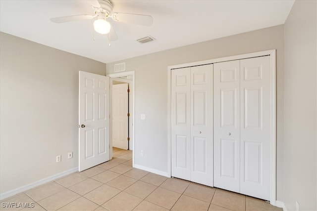 unfurnished bedroom with a closet, ceiling fan, and light tile patterned flooring