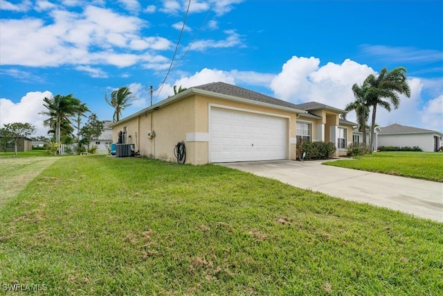 view of side of home with a lawn, cooling unit, and a garage