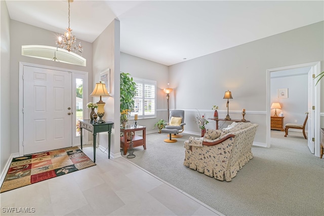 entrance foyer with a notable chandelier and light colored carpet