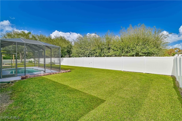 view of yard featuring a fenced in pool and a lanai