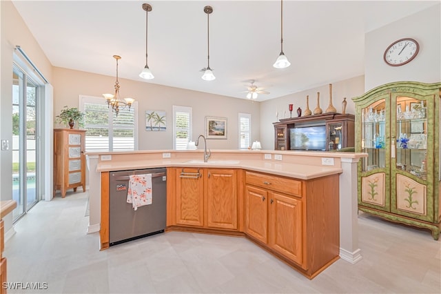 kitchen featuring dishwasher, hanging light fixtures, and an island with sink