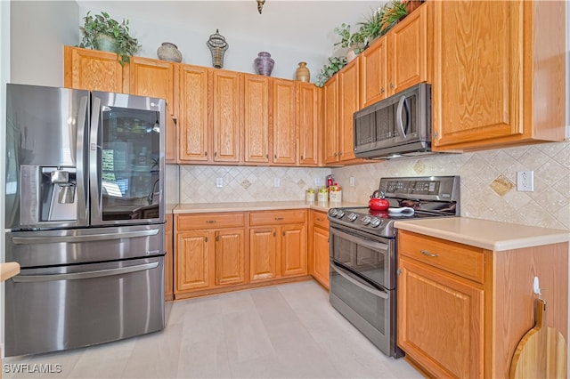 kitchen with stainless steel appliances and backsplash