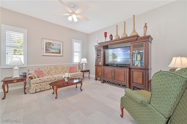 living room featuring ceiling fan and a wealth of natural light