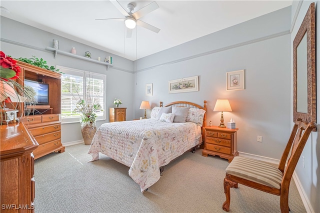 bedroom featuring light carpet and ceiling fan