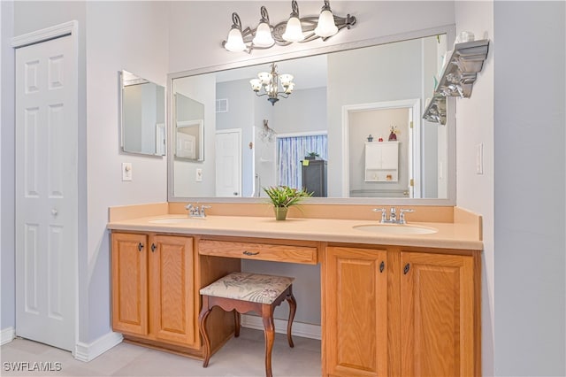 bathroom featuring vanity, a chandelier, and tile patterned flooring