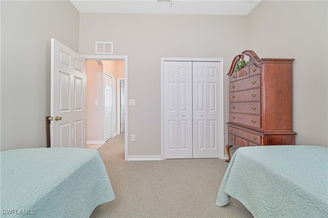 carpeted bedroom featuring a closet