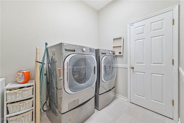 clothes washing area featuring separate washer and dryer