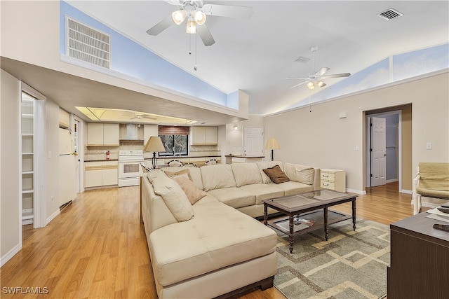 living room featuring high vaulted ceiling, ceiling fan, and light hardwood / wood-style floors