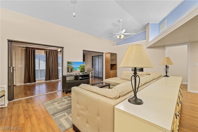 living room with high vaulted ceiling, light wood-type flooring, and ceiling fan