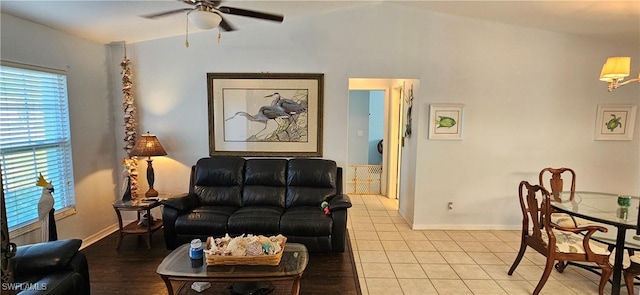 tiled living room featuring ceiling fan, a healthy amount of sunlight, and vaulted ceiling