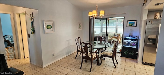 dining room featuring light tile patterned floors and a chandelier