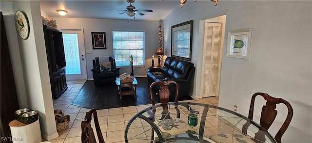 living room with light tile patterned floors, vaulted ceiling, and ceiling fan