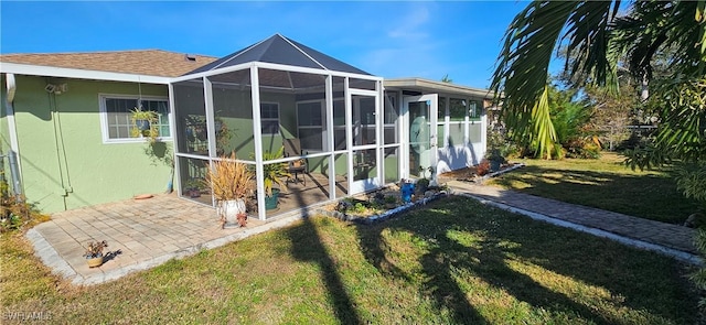 back of property with a patio area and a yard