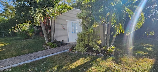 view of outbuilding featuring a lawn