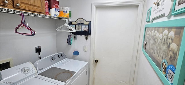 clothes washing area with washer and clothes dryer