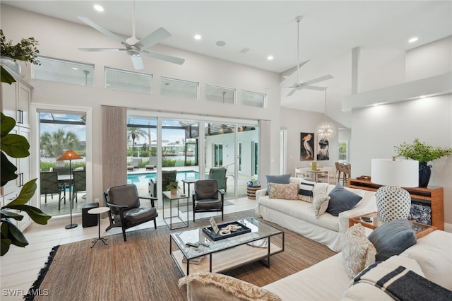 living room with ceiling fan and a high ceiling