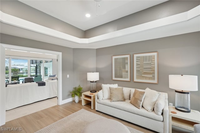 living room featuring hardwood / wood-style flooring and ceiling fan