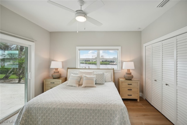 bedroom featuring a closet, ceiling fan, light hardwood / wood-style floors, and access to exterior