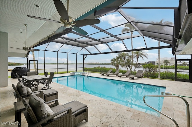 view of pool with ceiling fan, a patio area, and a lanai