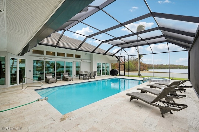 view of pool featuring a patio area, a lanai, a water view, and ceiling fan