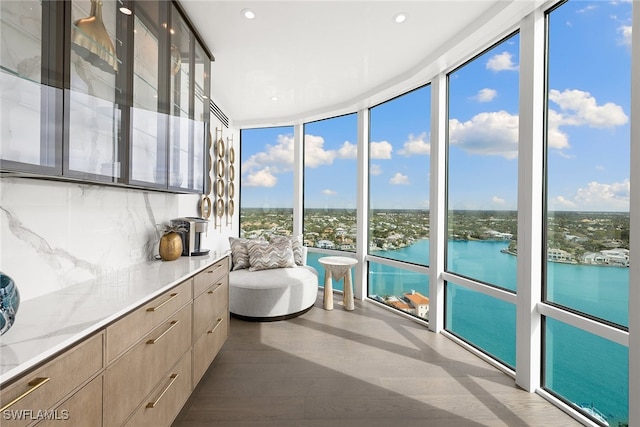 unfurnished sunroom with a water view