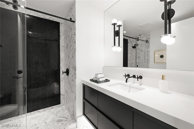 bathroom featuring vanity and a shower with shower door