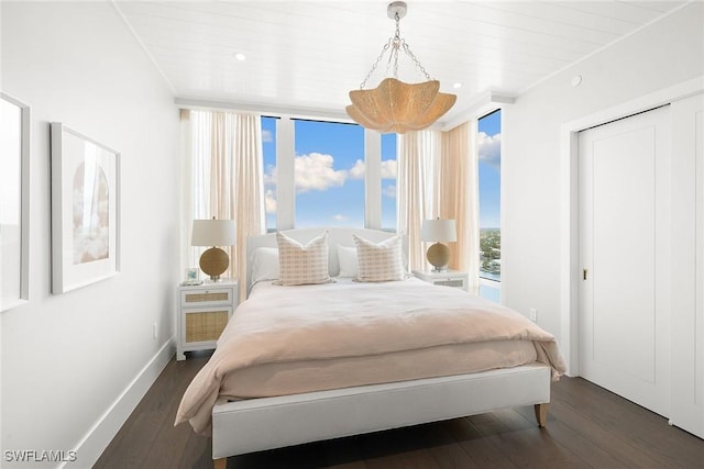 bedroom featuring dark wood-type flooring and baseboards