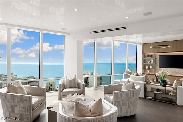 living room featuring dark wood-type flooring, a wall of windows, a water view, and built in features