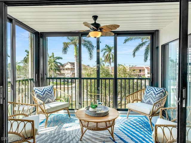 sunroom featuring ceiling fan and a wealth of natural light