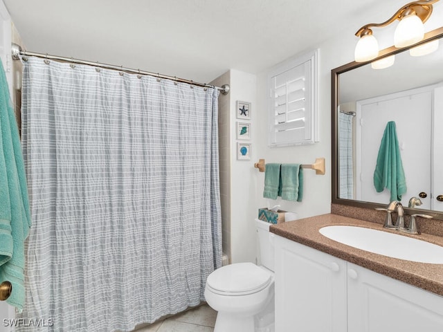 bathroom with vanity, curtained shower, toilet, and tile patterned flooring