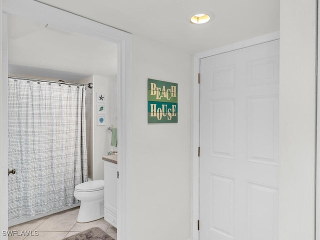 bathroom featuring vanity, toilet, tile patterned floors, and a shower with curtain