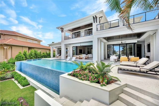 view of swimming pool with an outdoor hangout area, ceiling fan, and a patio area