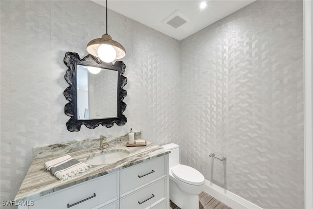 bathroom with vanity and toilet