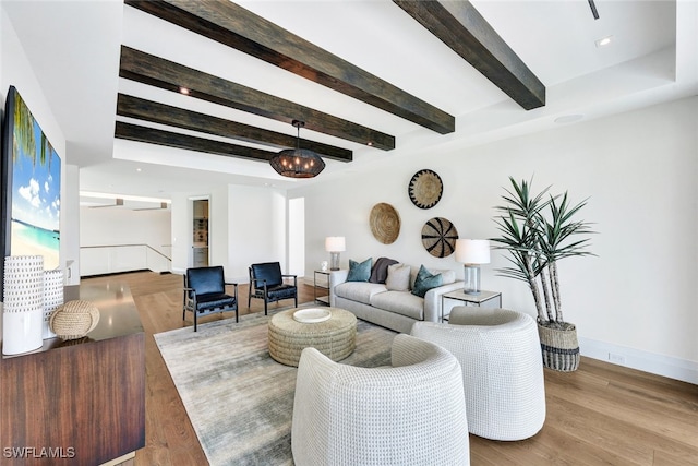 living room with light hardwood / wood-style floors and beamed ceiling