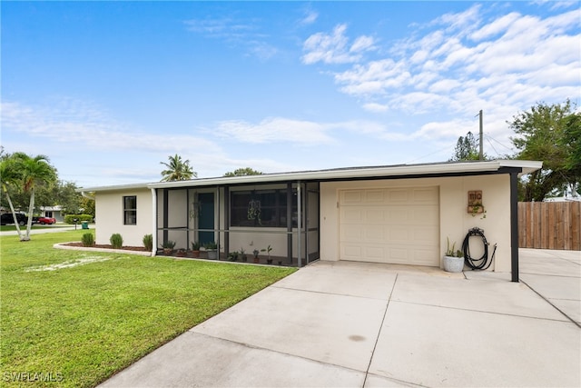 ranch-style house featuring a front yard, a garage, and a sunroom