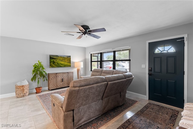 tiled living room with ceiling fan