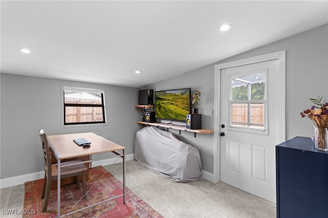 office with lofted ceiling and tile patterned flooring