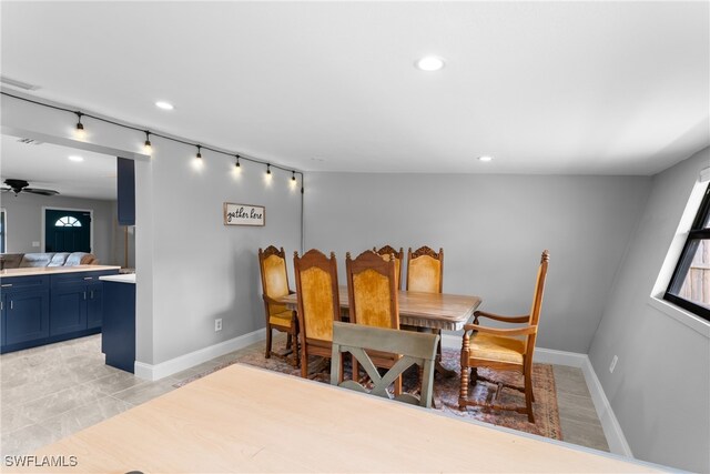 dining space featuring light wood-type flooring and ceiling fan