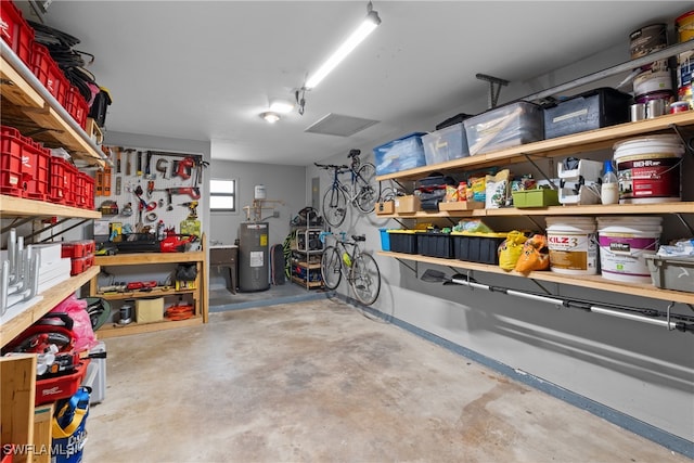 garage featuring a workshop area and electric water heater