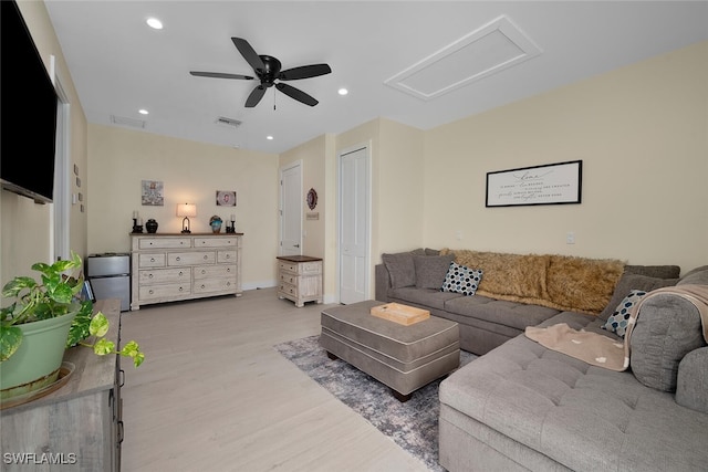 living room featuring ceiling fan and light hardwood / wood-style floors