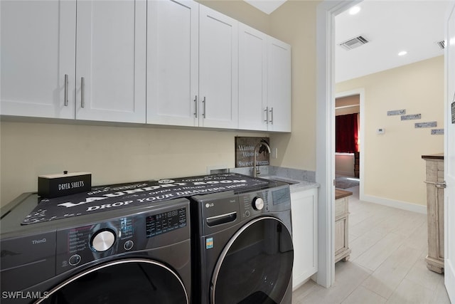 clothes washing area featuring cabinets, separate washer and dryer, and sink