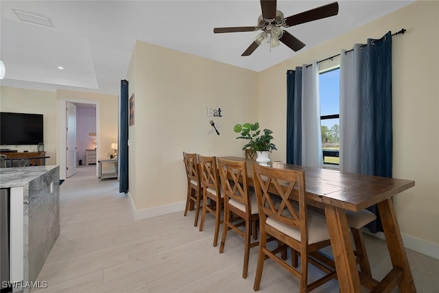 dining room featuring ceiling fan and light hardwood / wood-style flooring