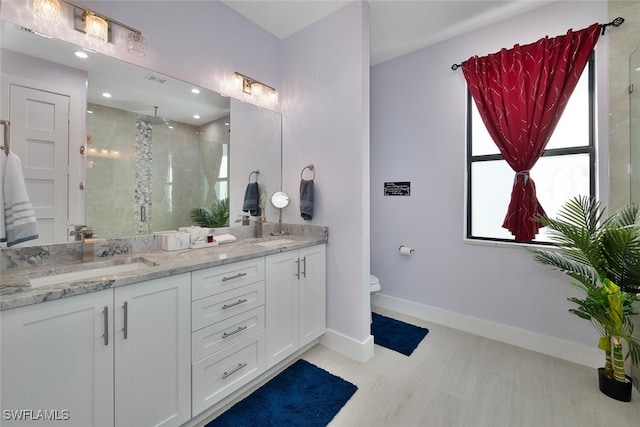 bathroom featuring vanity, toilet, and an enclosed shower