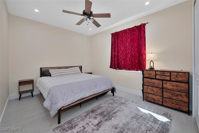 bedroom with light wood-type flooring and ceiling fan