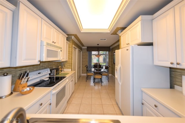 kitchen with hanging light fixtures, white cabinets, light tile patterned floors, white appliances, and a skylight