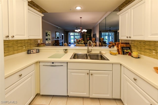 kitchen with white cabinets, dishwasher, sink, kitchen peninsula, and a chandelier