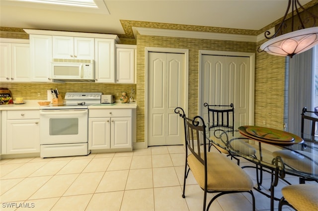 kitchen featuring pendant lighting, white cabinetry, white appliances, and light tile patterned floors