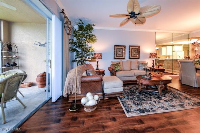 living room with ceiling fan, dark wood-type flooring, and crown molding