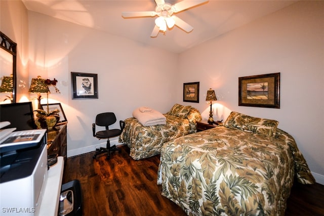 bedroom featuring ceiling fan, dark hardwood / wood-style flooring, and vaulted ceiling